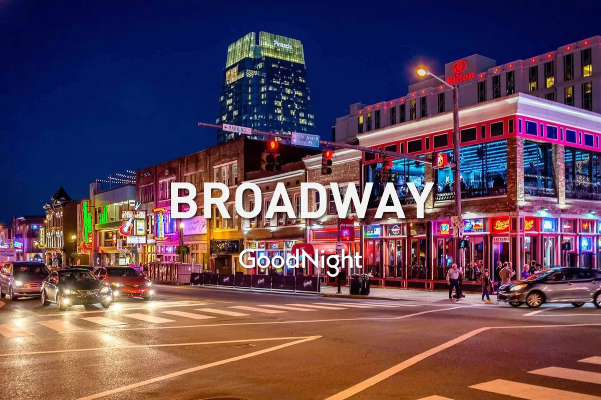 This exterior shot captures Nashville’s energetic nightlife scene, featuring neon signs, illuminated buildings, bustling streets, and groups of people enjoying the city. The vibrant colors and movement evoke the excitement and festive atmosphere found on Broadway and other renowned music districts.